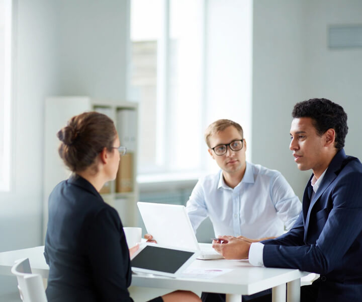 Smart Business Partners Communicating at Meeting